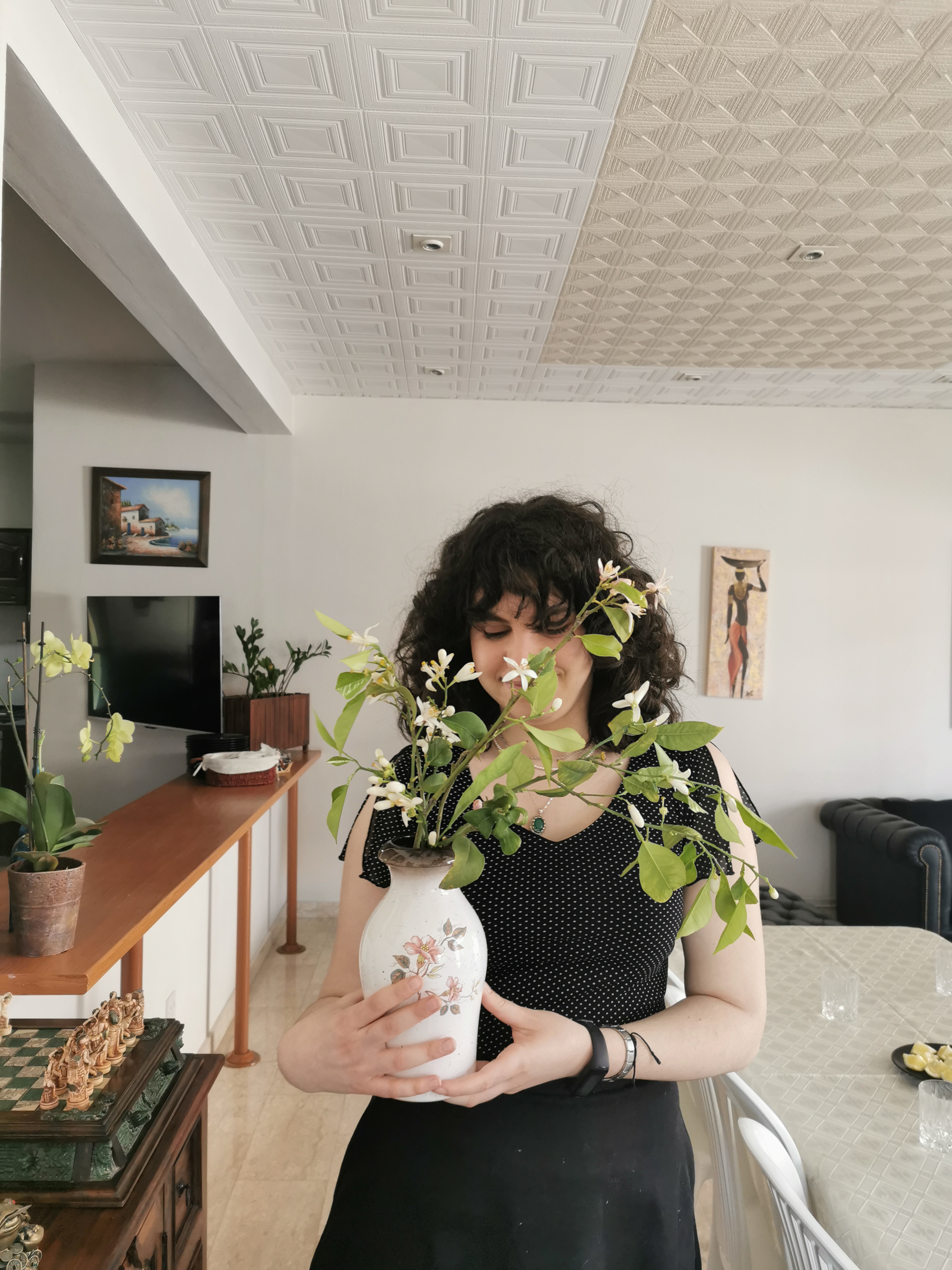 A picture of myself holding a vase filled with lemon blossoms from Cyprus.