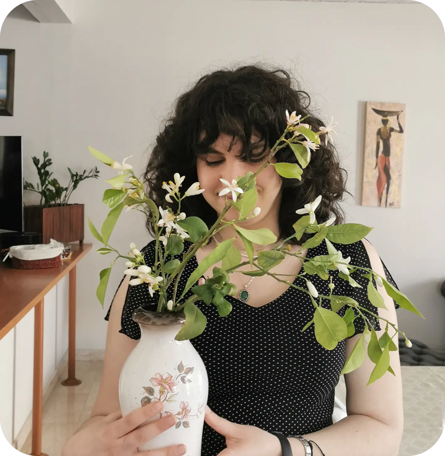 A picture of myself holding a vase filled with lemon blossoms from Cyprus.